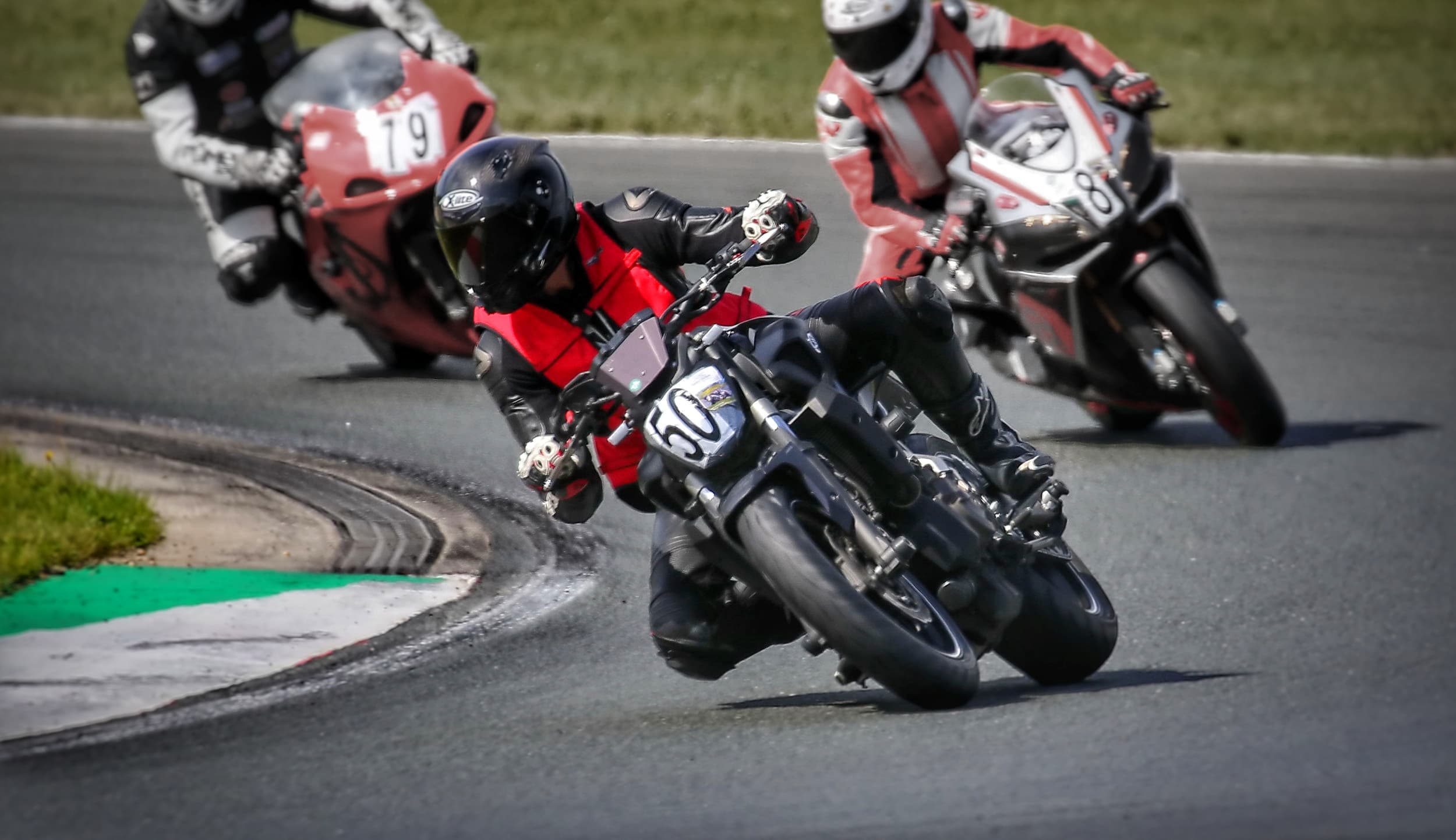 A picture of Alexander Oliver Mader riding his motorcycle (a Yamaha MT 07) at the racetrack Motorsport Arena in Oschersleben, Germany.